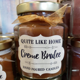 Creme Brulee scented 6.5 oz. jar candle with gold lid, and organza ribbon.