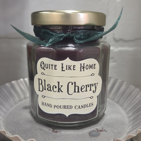 Black Cherry scented 6.5 oz. jar candle with gold lid, and organza ribbon.