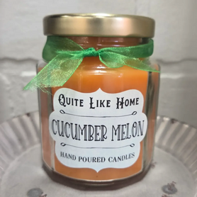 Cucumber Melon scented 6.5 oz. jar candle with gold lid and organza ribbon.