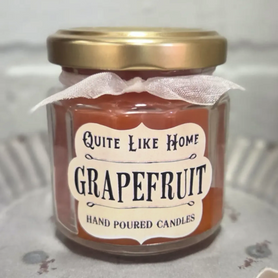 Grapefruit scented 4 oz. jar candle with gold lid and organza ribbon