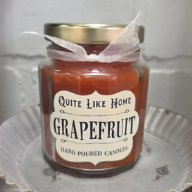 Grapefruit scented 6.5 oz. jar candle with gold lid and organza ribbon