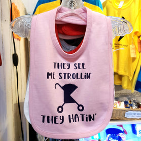 They see me strollin', they hatin' funny 100% cotton infant bib w/ Velcro closure.