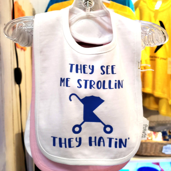 They see me strollin', they hatin' funny 100% cotton infant bib w/ Velcro closure.