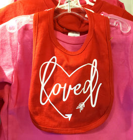 Loved surrounded by a heart shaped arrow bib.