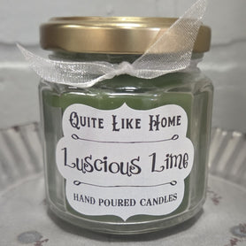 Lime scented 4 oz. jar candle with gold lid and organza ribbon.