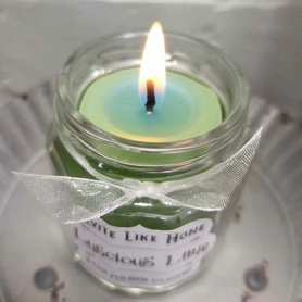 Lime scented 4 oz. jar candle with gold lid and organza ribbon.