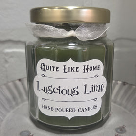 Lime scented 6.5 oz. jar candle with gold lid and organza ribbon.