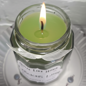 Lime scented 6.5 oz. jar candle with gold lid and organza ribbon.