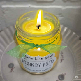 Monkey Farts scented 4 oz. jar candle with gold lid, and organza ribbon