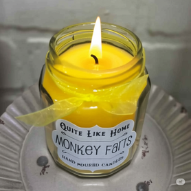 Monkey Farts scented 6.5 oz. jar candle with gold lid, and organza ribbon.