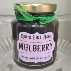 Mulberry scented 6.5 oz. jar candle with gold lid, and organza ribbon.