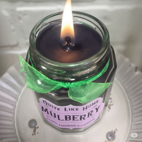 Mulberry scented 6.5 oz. jar candle with gold lid, and organza ribbon.