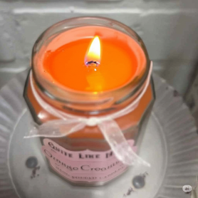 Orange Creamsicle scented 6.5 oz. jar candle with gold lid, & organza ribbon.
