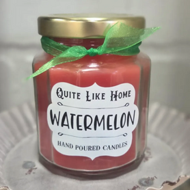 Watermelon scented 6.5 oz. jar candle with gold lid, and organza ribbon.