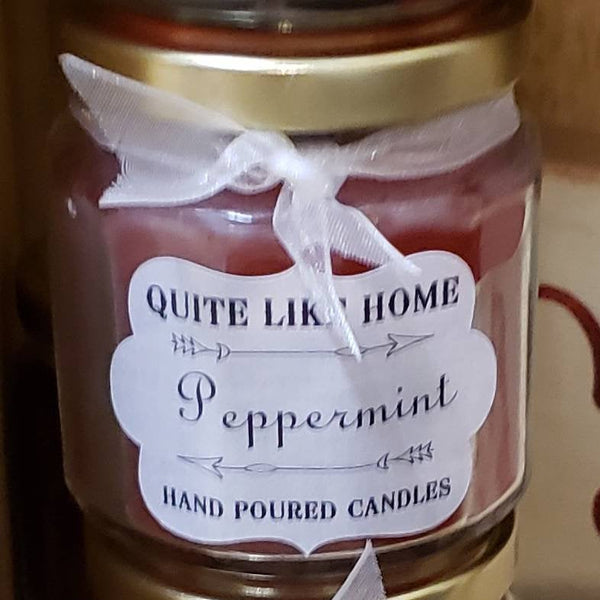 Peppermint scented 4 oz. jar candle with gold lid, and organza ribbon.