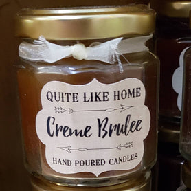 Creme Brulee scented 4 oz. jar candle with gold lid, and organza ribbon.