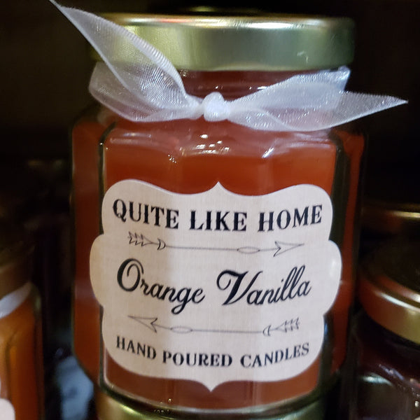 Orange Creamsicle scented 6.5 oz. jar candle with gold lid, & organza ribbon.