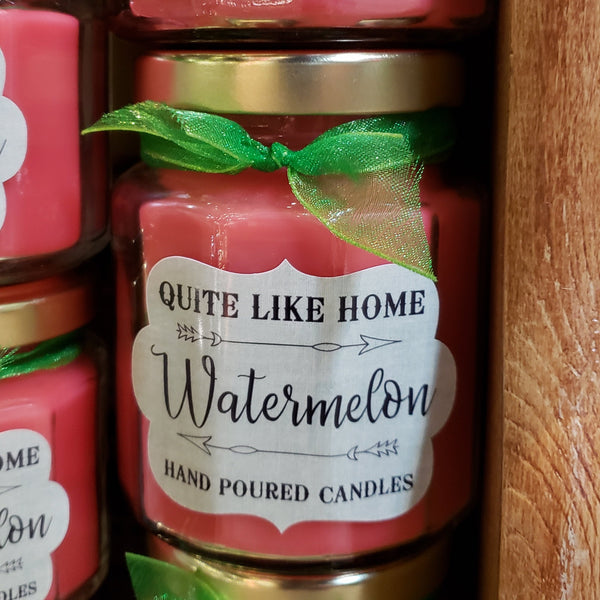 Watermelon scented 6.5 oz. jar candle with gold lid, and organza ribbon.