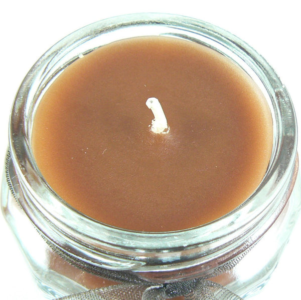 Leather scented 4 oz. jar candle with gold lid, and organza ribbon.