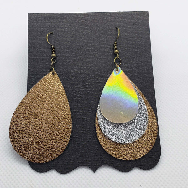 Triple stacked gold, silver, and bronze teardrop shaped faux leather earrings